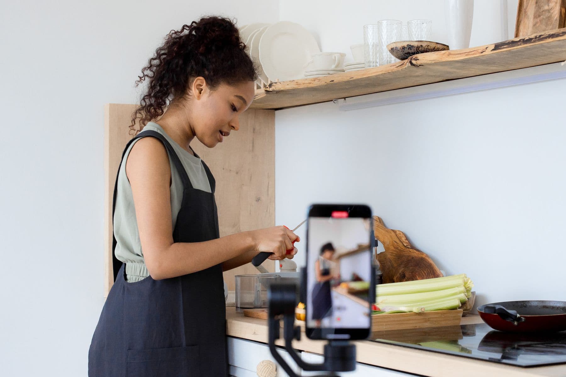 A woman recording community education content on her phone.